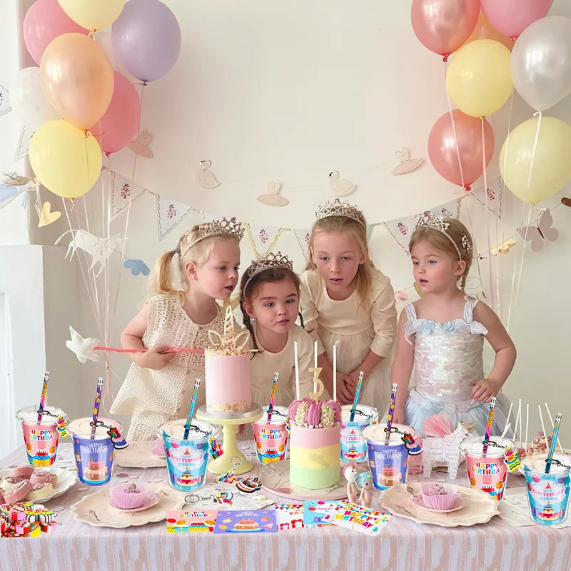 Four young girls celebrating with pink and yellow balloons and birthday party goodie bags