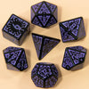 A set of seven fantasy carved polyhedral dice in purple and black on a light background.