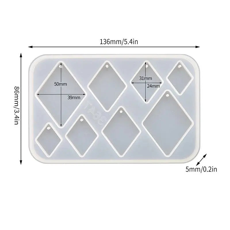 A white silicone mold set with various diamond-shaped cavities for making epoxy resin earrings and pendants.