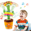 A young boy is smiling while holding an interactive talking cactus toy with colorful features and musical notes.