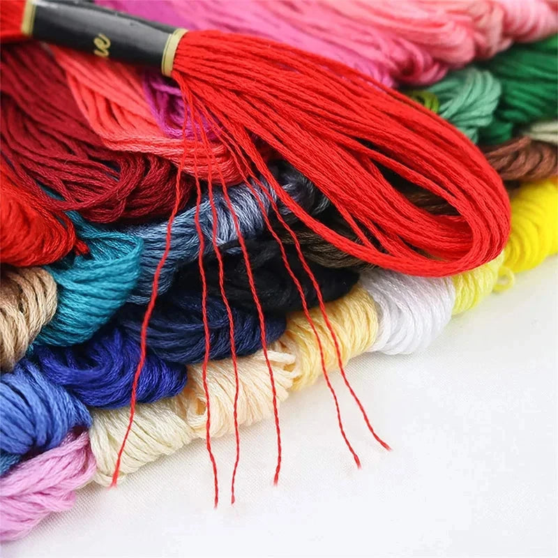A colorful bundle of vibrant organic cotton embroidery floss in various shades including red, pink, blue, green, and yellow.