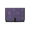 Purple fabric diaper changing pad with a white swan pattern and a black closure.