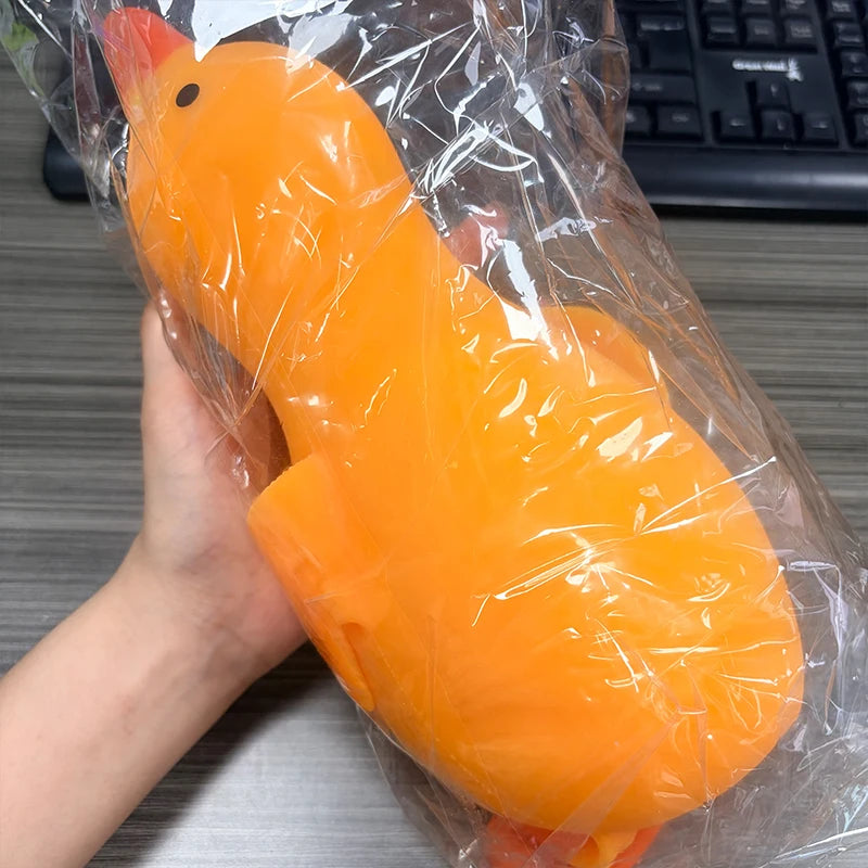 An orange jumbo duck squishy stress relief toy is visible inside clear plastic packaging.