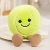 A bright lime green plush doll shaped like a sports ball with small black eyes and tan limbs.