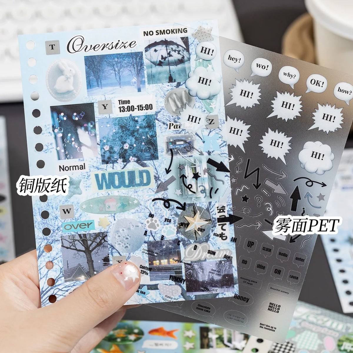 A hand holds a sheet of Kawaii K-pop sticker and photocard sheets featuring various text and illustrations for crafting.