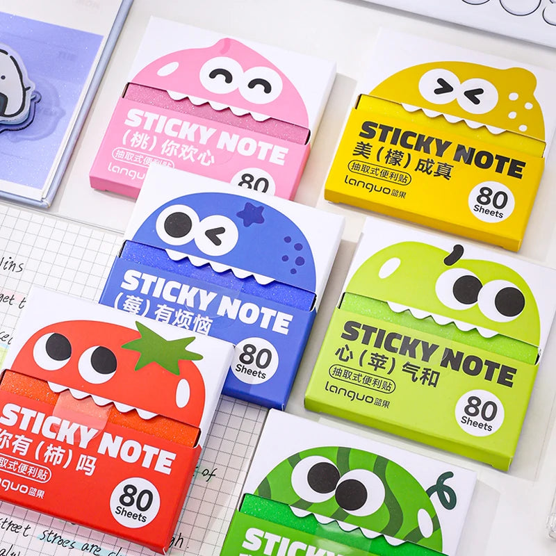 A collection of colorful sticky notes in various shapes and colors, including pink, yellow, and green, packaged for sale.