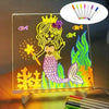 An LED acrylic message board featuring a princess design and seven colored pens.