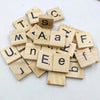 A collection of wooden alphabet letter tiles spelling out letters like T, L, S, E, F, J, and U, used for DIY crafts or games.