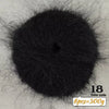 A dark black ball of long-haired alpaca blend yarn for knitting, labeled as 18 and weighing 300g.