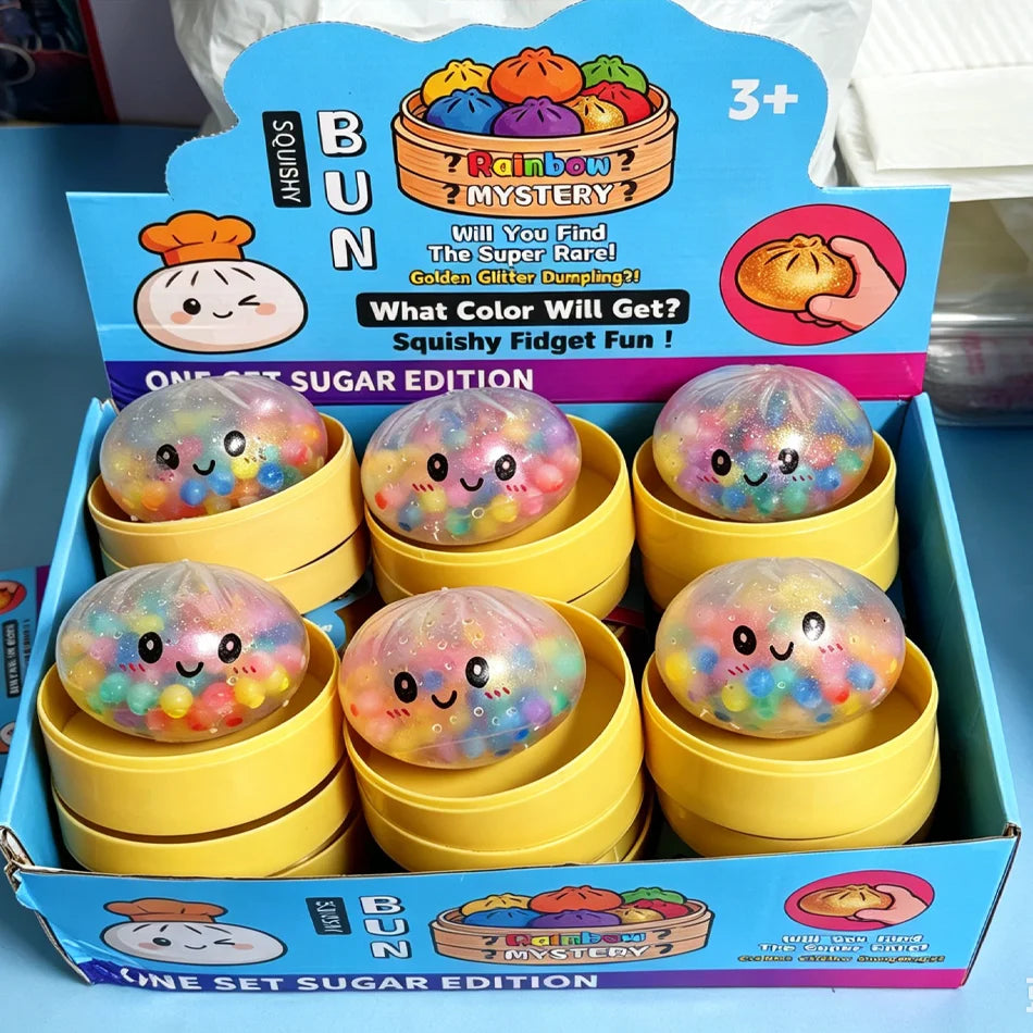 A box of Rainbow Mystery Glitter Dumpling Squishy Fidget Fun toys in yellow packaging