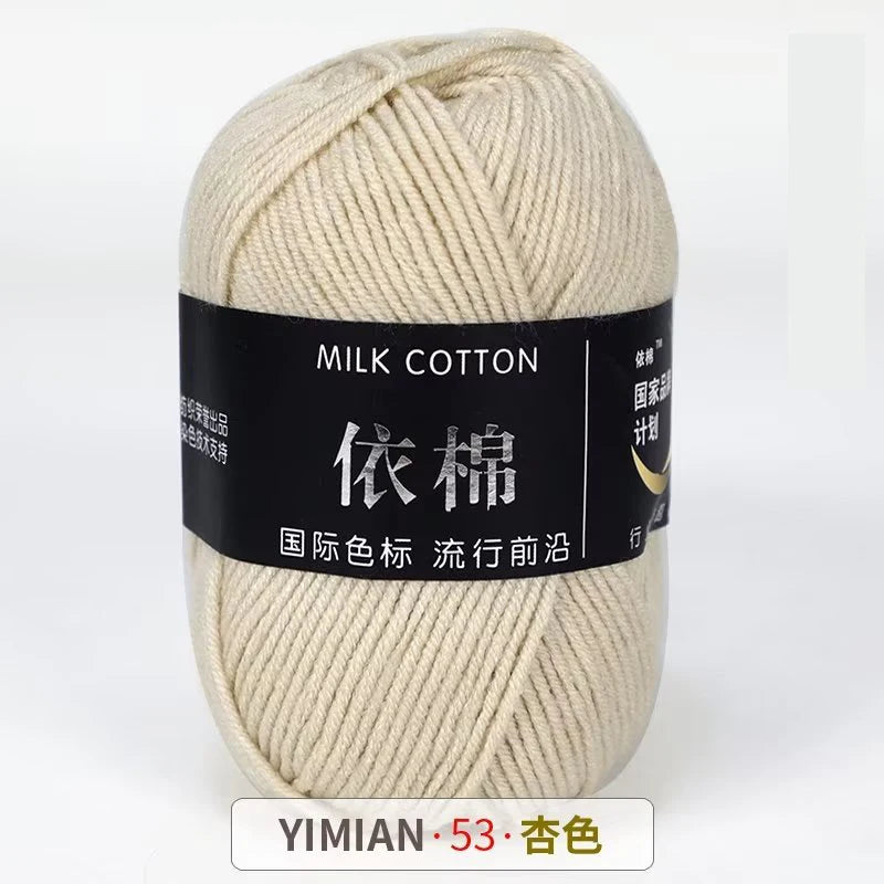 A ball of cream colored milk cotton yarn labeled with Chinese text and a price tag.