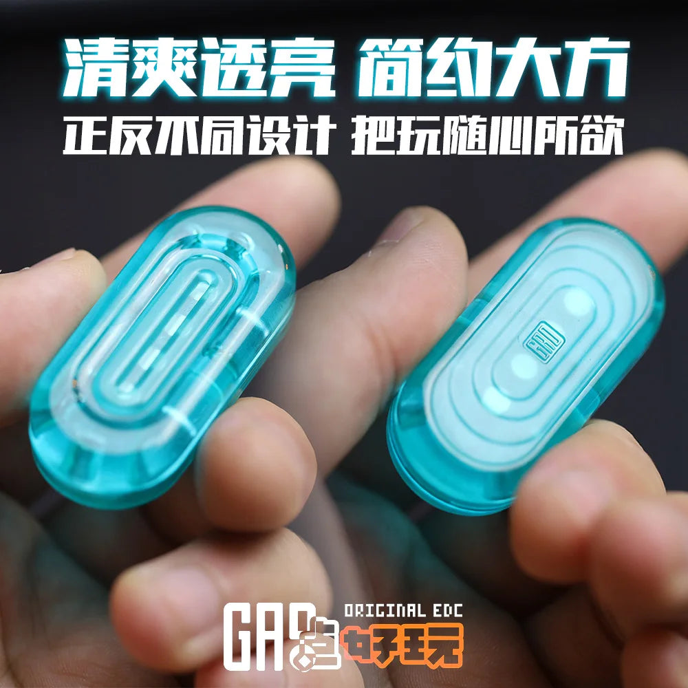 A hand holds two clear blue silicone EDC push slider fidget toys for stress relief.