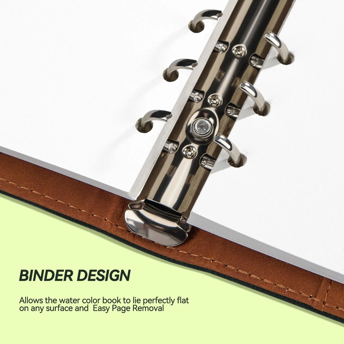 Close-up view of a binder design on a watercolor sketchbook showing metal rings and leather binding.