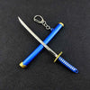 A samurai sword keychain with a blue hilt and silver blade, crossed, hanging from a metal ring.