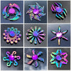 A collection of eight rainbow metal fidget spinners showing various colors and designs.