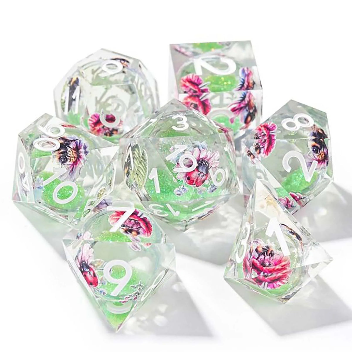 A set of seven pink floral butterfly resin polyhedral dice for tabletop role-playing games