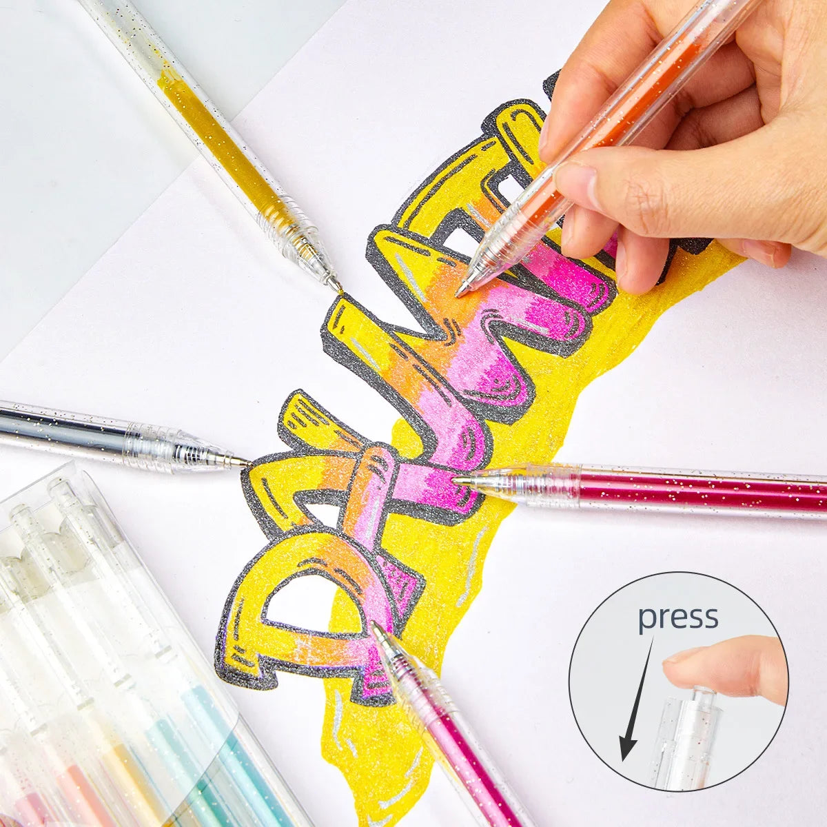 A hand is using glitter gel pens to write colorful lettering on a white surface.