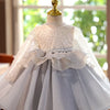 A white and gray tulle princess dress displayed on a mannequin.