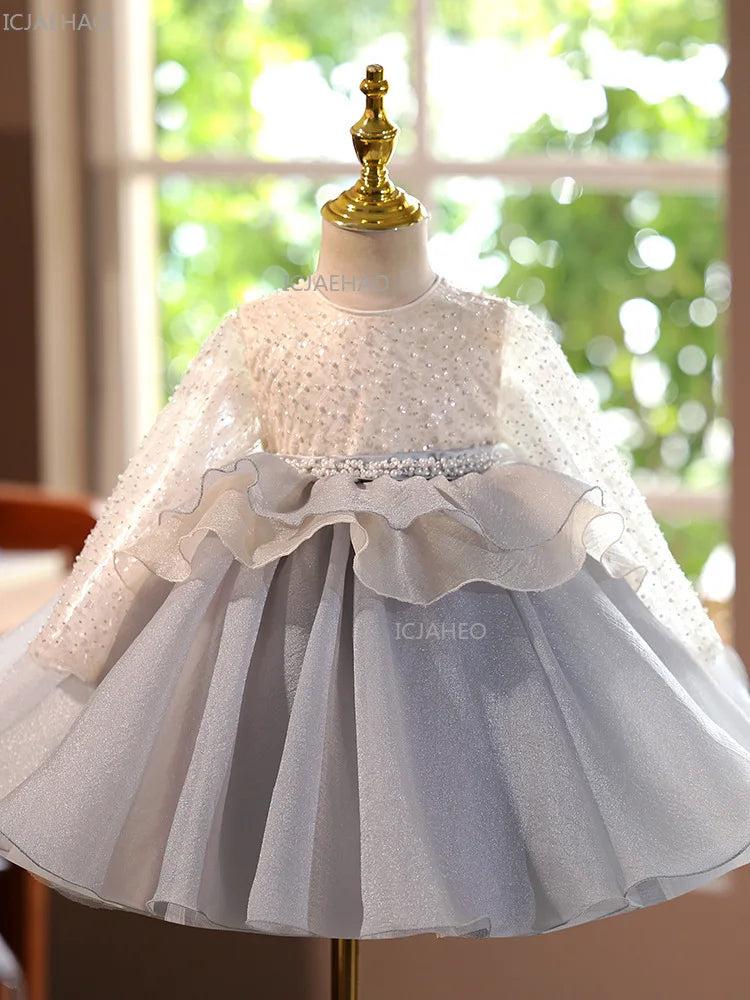 A white and gray tulle princess dress displayed on a mannequin.