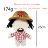 A plush doll resembling Eminem, XXXTentacion, and Frank Ocean with dark hair, a brown hat, and a red heart design.
