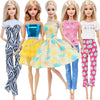 Five fashion dolls wearing casual outfits and jeans in various colors and patterns