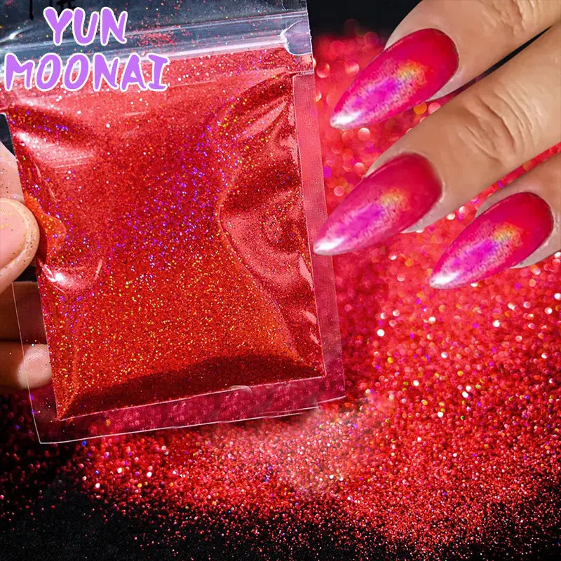A hand displays vibrant red holographic nail glitter product with iridescent pink and red nail polish on fingers.