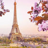 A painting of the Eiffel Tower framed by pink blossoms and green foliage against a soft sky.