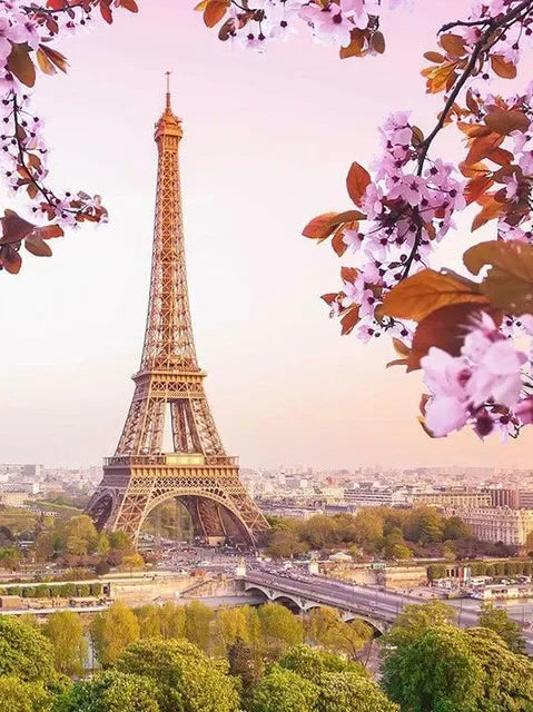 A painting of the Eiffel Tower framed by pink blossoms and green foliage against a soft sky.