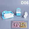 A set of light blue dollhouse furniture including a bathtub, toilet, and various accessories for a 1:12 scale dollhouse
