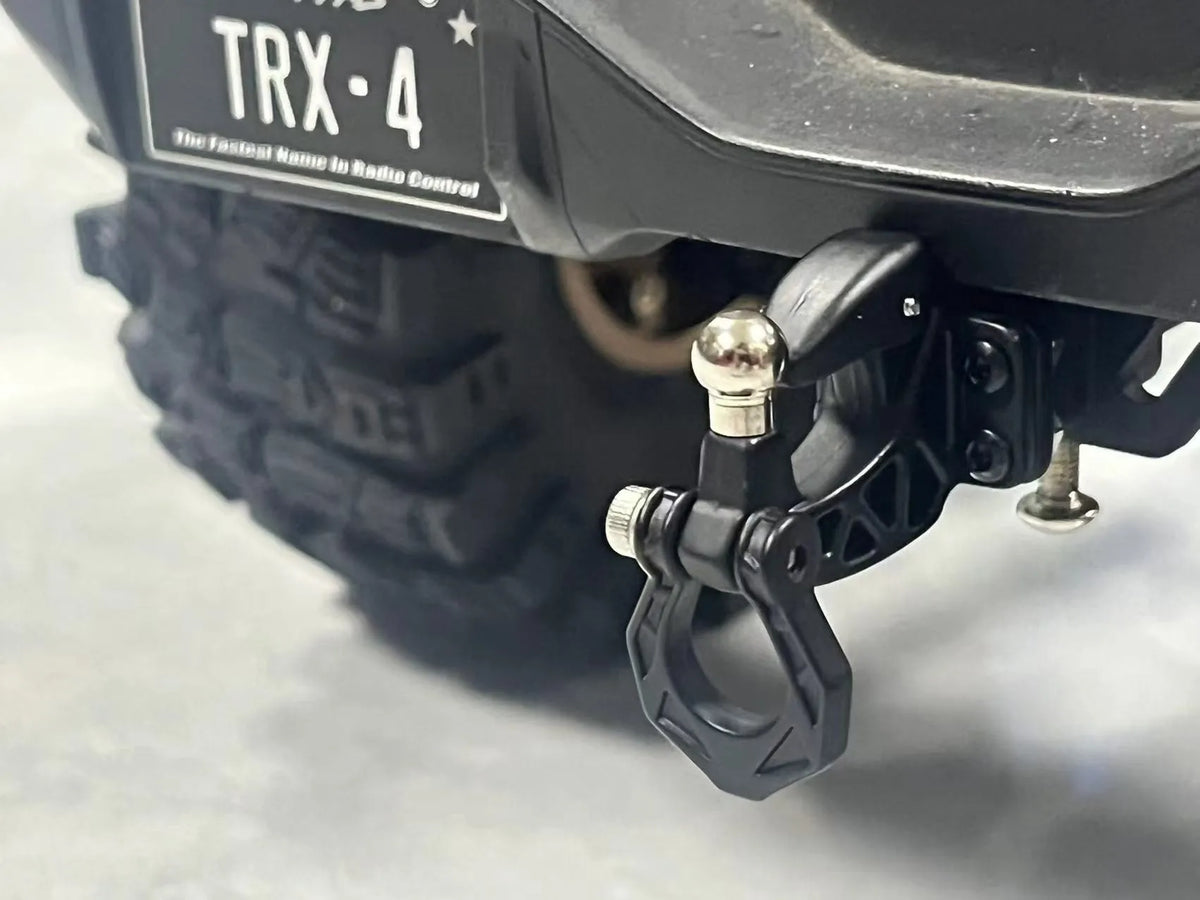 Close-up of a black metal trailer hitch receiver for an RC crawler car.