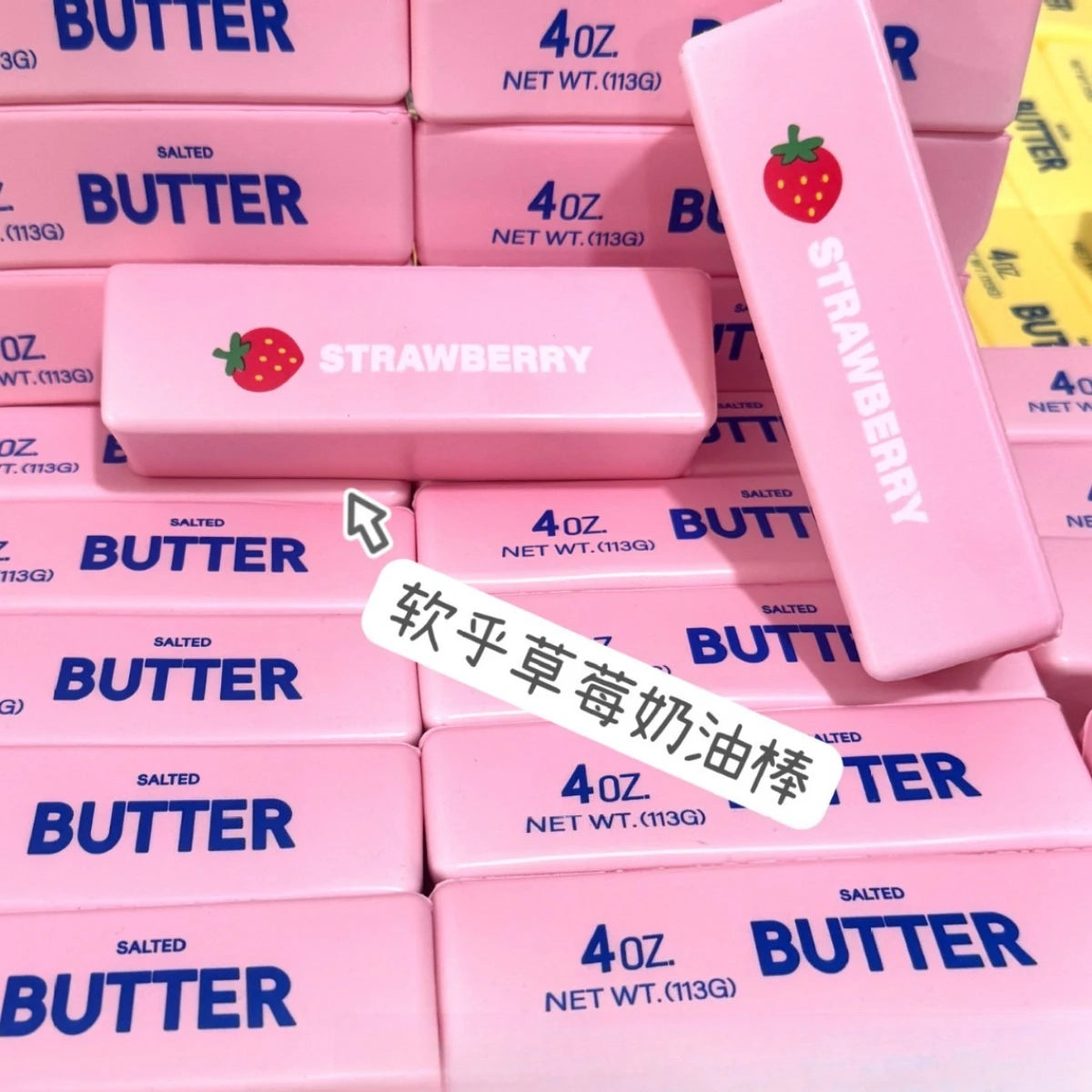 Pink squishy butter blocks with strawberry designs and the Strawberry Butter Squishy fidget toy