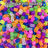 A close-up view of a large quantity of transparent mixing fuse beads in assorted bright colors.