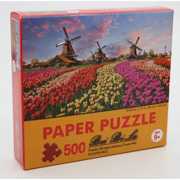A box for a 500 piece landscape jigsaw puzzle featuring windmills and colorful flowers.