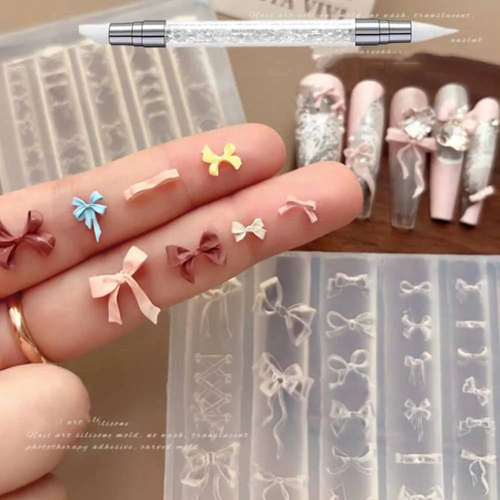 A hand displays various silicone nail molds shaped like bows and flowers, alongside a carving pen.