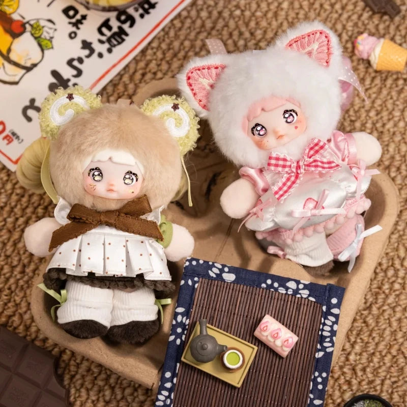 A cute plush keychain featuring a character with pink and white fur, wearing a pink patterned outfit.