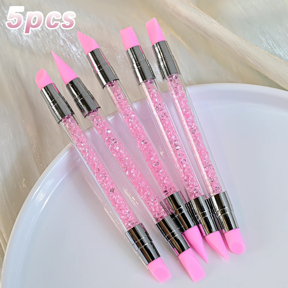A set of five double-ended silicone dotting pens with pink tips and clear bodies for art and sculpting.