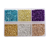 A clear plastic tray filled with various colors of crushed glass stones including blue, gold, purple, silver, and bronze.