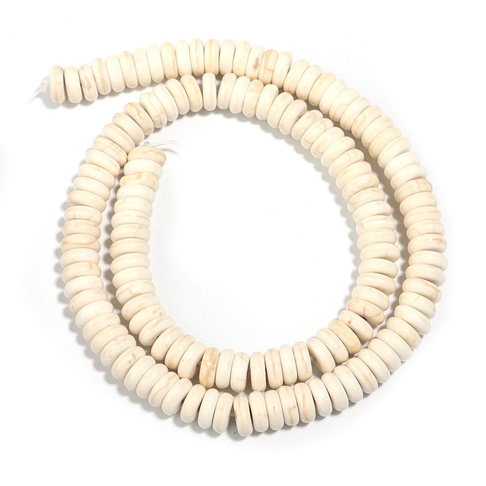 A strand of natural light beige turquoise stone beads coiled into a circular shape.