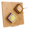 A wooden bamboo crochet blocking board with pins and a stand holding several colorful knitted squares.