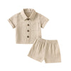 A beige knitted baby boy cotton linen shirt and matching shorts outfit set.