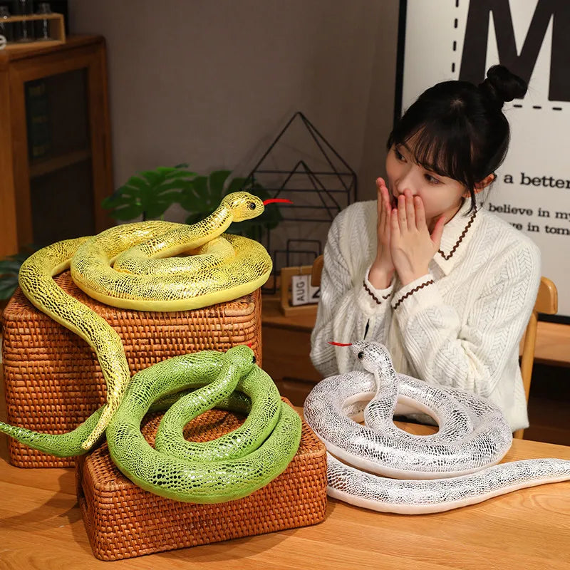 A woman holds her hands to her mouth while looking at a pile of realistic yellow and green snake plush toys.