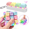 A hand holds a colorful LED fidget keychain with nine tactile buttons, showing various pastel colors.