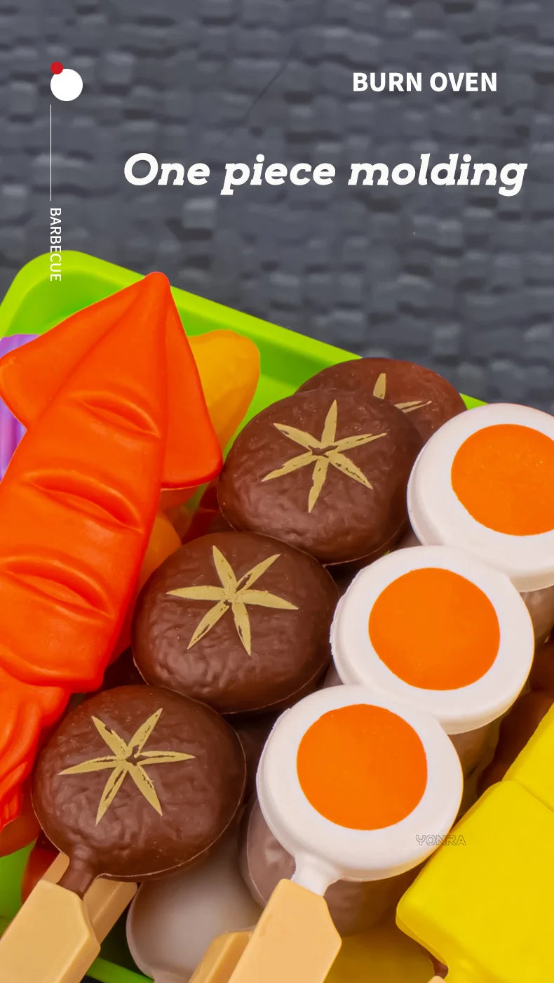 A single piece molding of a brown food item is shown in a green play kitchen set with various colorful food pieces.