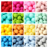 A collection of soft silicone beads in various shades of pink, green, yellow, and beige.