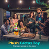 A group of people interacting with a plush cactus toy that can twinkle in the dark.
