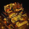 A detailed miniature dollhouse puzzle kit featuring wooden structures and decorative elements.