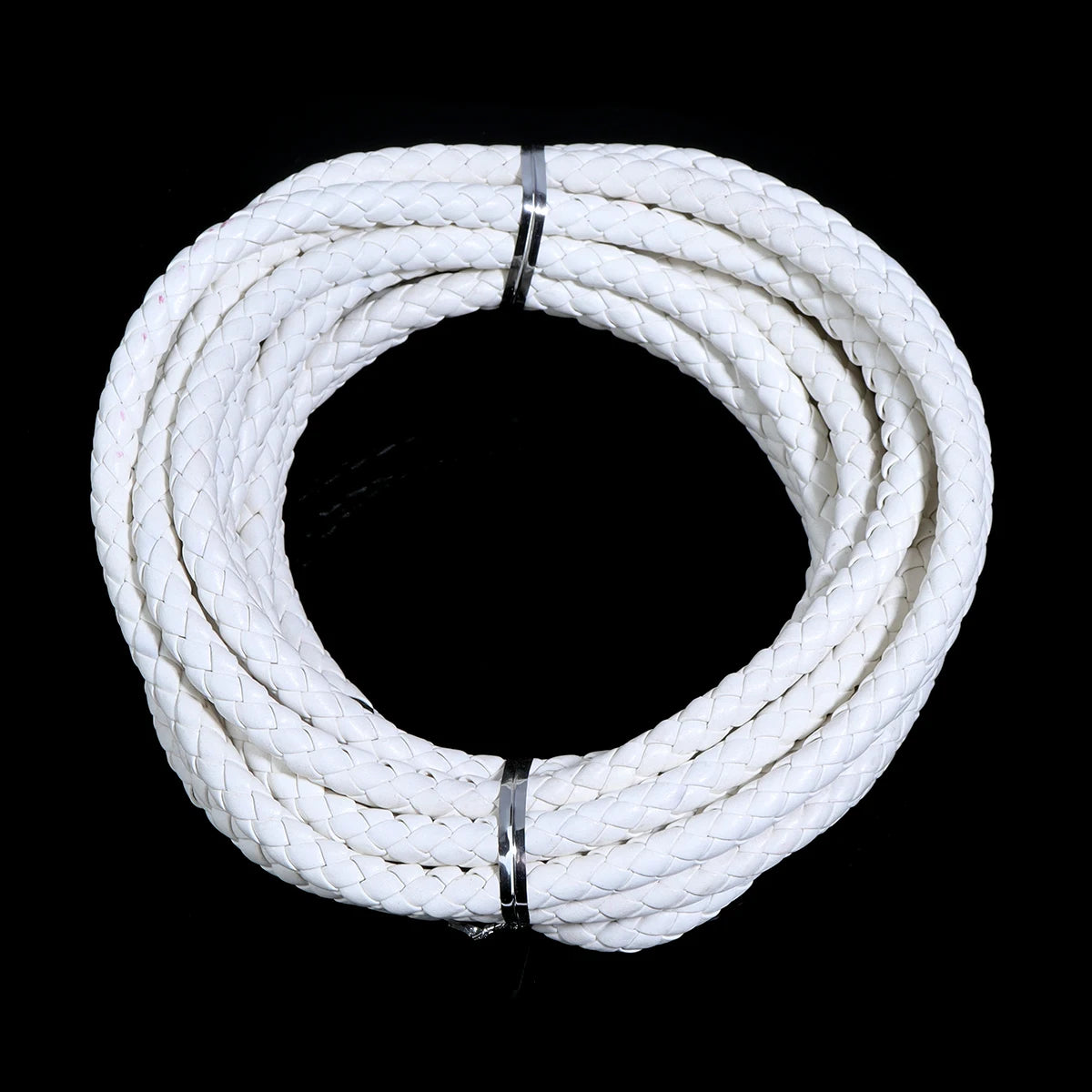 A coil of white round braided leather cord for jewelry making and DIY crafts.