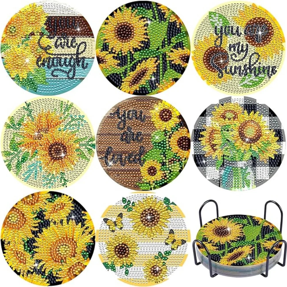 A set of DIY floral diamond painting coasters featuring yellow and green flowers with a metal holder.