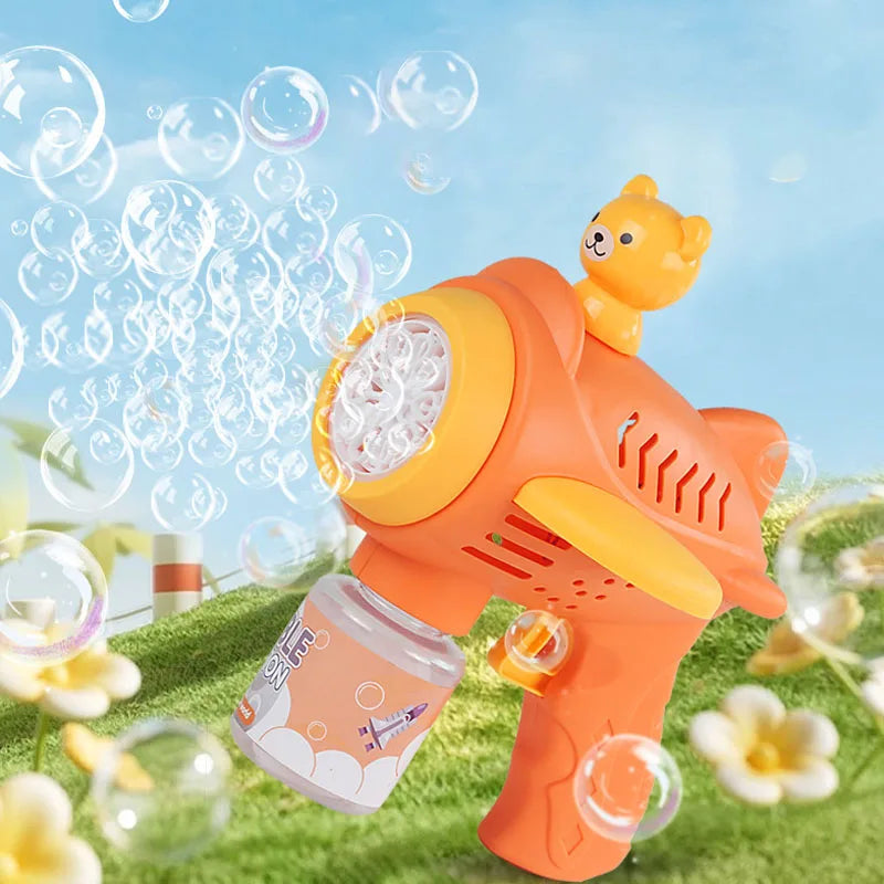 An orange bear-shaped automatic bubble gun with lights is shown spraying bubbles in a green outdoor setting.