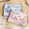 A set of two color border sticker sheets for journaling and scrapbooking displayed on a light brown textured surface.